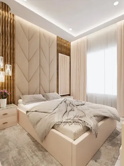 A beautiful bedroom design combining textures for a warm, inviting feel. The room features a chevron-patterned upholstered headboard, vertical wooden fluting, and elegant hanging pendant lights next to the bed.
