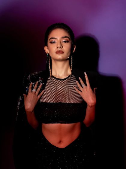 A powerful close-up from the GQ shoot. The direct, confrontational pose and dramatic lighting create a strong, memorable image.