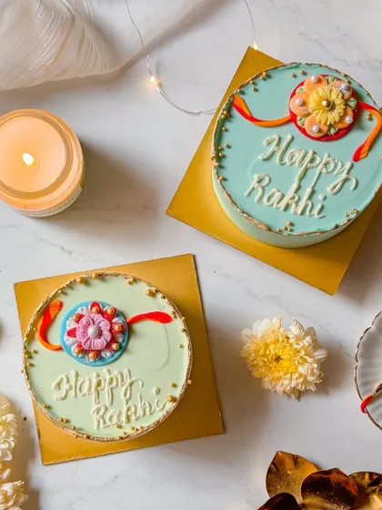 Two of our Rakhi mini cakes in different colours, pastel green and blue. This shows the option for personalization and choice, even in our smaller festive cakes.