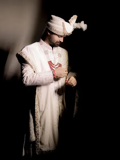 A classic, dramatic portrait of the groom. Using shadow and light, I create a timeless and sophisticated image that captures his quiet confidence and anticipation on the wedding day.