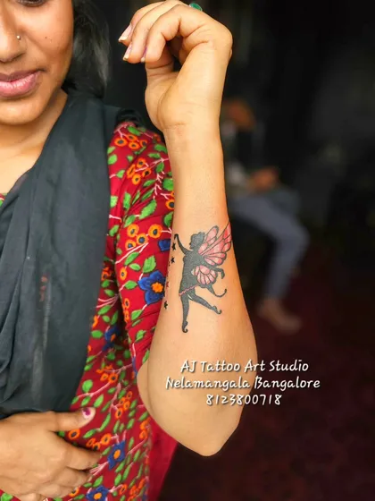 For those who want something magical, I create designs like this fairy with pink wings scattering stars. It's a delicate and whimsical forearm piece that adds a touch of fantasy.