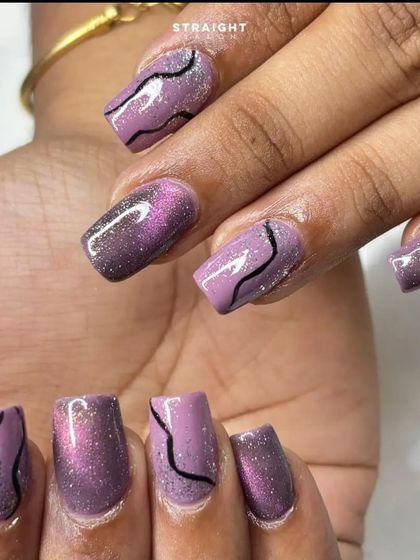 A close-up of the purple cat-eye and black swirl design. The combination of the shimmer, glitter, and bold lines creates a lot of visual interest.