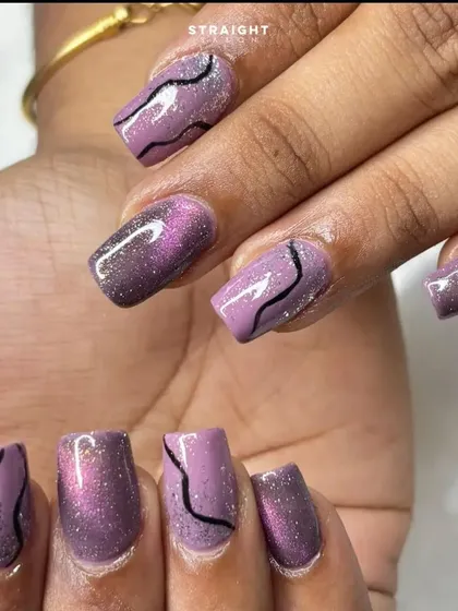 A close-up of the purple cat-eye and black swirl design. The combination of the shimmer, glitter, and bold lines creates a lot of visual interest.