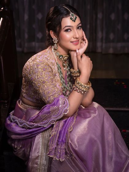 A sweet, candid moment. This close-up shows the soft pink lip and subtle shimmer on the eyes that give her that bridal glow.