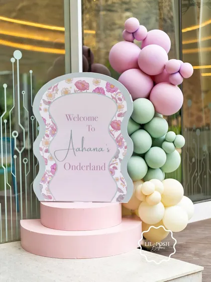 The welcome sign for "Aahana's Onderland," featuring the same beautiful floral print and soft colors used throughout the event decor.