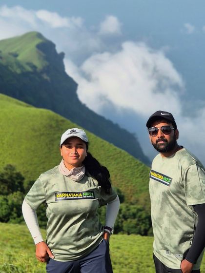 Two of our trek leads in our official gear, posing against the stunning backdrop of the Bandaje hills.