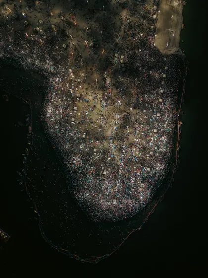 A top-down view of the massive crowd gathered for the holy dip (Snan) at the Mahakumbh, looking like a constellation of human souls.