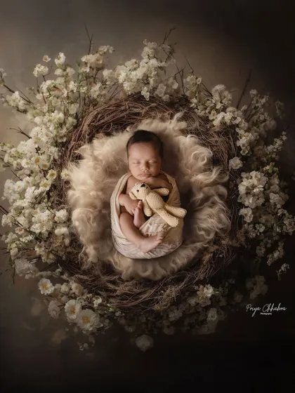 Nestled in a bed of soft white flowers, this little one is peacefully dreaming. My studio sessions use beautiful props and textures to create artistic, magazine-style portraits of your baby.