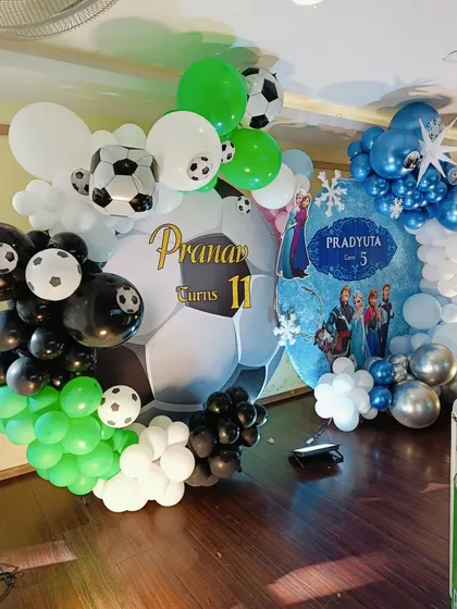 A detailed view of the football-themed balloon arrangement, with a giant soccer ball backdrop.