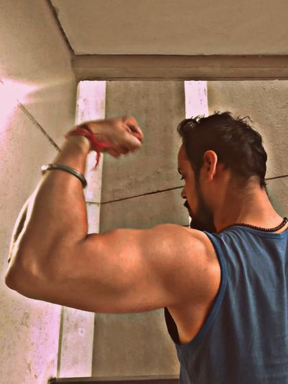 Hustle for that muscle. A simple bicep flex showcasing the results of consistent training. Every workout contributes to building the physique you want.