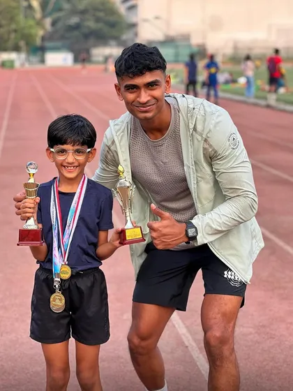 Two trophies, multiple medals, and one very happy athlete. Posing with one of our rising stars after he dominated his school's sports day.