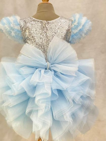 The back of our "Frozen" dress is just as magical, with a large, fluffy bow made of blue tulle that completes the icy princess look.