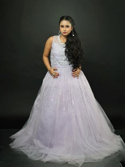 A classic pose in the lavender rental gown. The sleeveless design is perfect for warmer weather or indoor events.