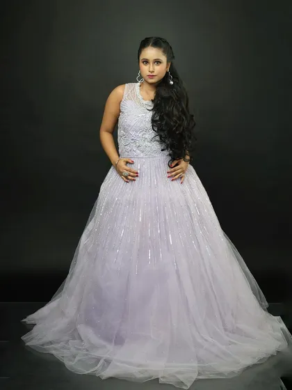 A classic pose in the lavender rental gown. The sleeveless design is perfect for warmer weather or indoor events.