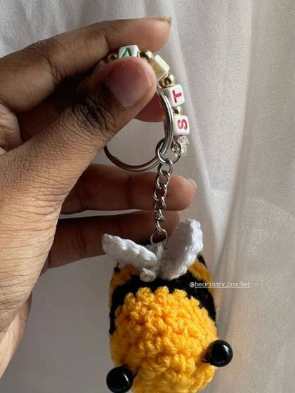A close-up view of the letter beads on a custom name bee keychain. It's a small detail that makes each handmade gift feel so personal.