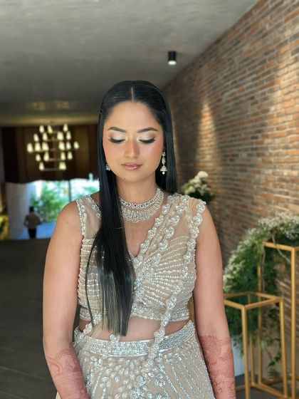 A close-up, eyes-closed shot to highlight the shimmery, glamorous eye makeup.