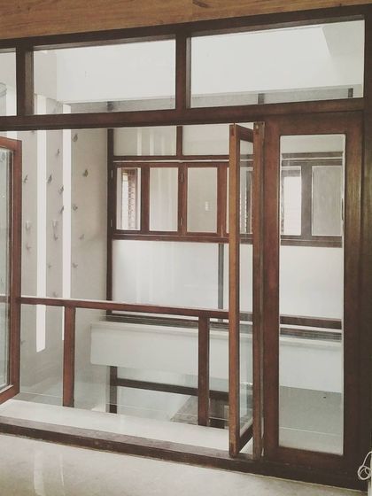 This internal balcony features sliding and folding wooden doors that can open up completely, connecting the living room to a guest room across the lightwell.