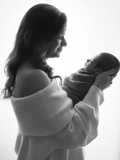 A mother's love, captured in a timeless silhouette. This black and white portrait is simple, elegant, and full of emotion.