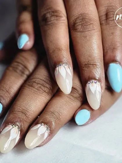 An elegant combination of baby blue and nude with a delicate white floral design and rhinestone accents. This student work is clean, precise, and beautiful.