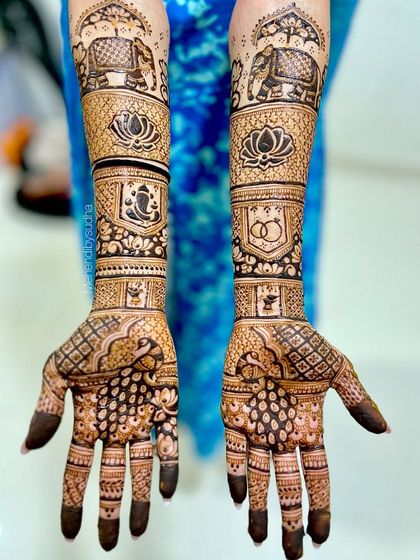 A beautiful engagement design incorporating auspicious symbols like Lord Ganesha and the lotus, alongside elephant motifs and the classic symbol of two rings.