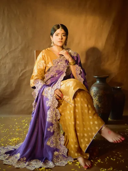A full-length portrait that captures the complete royal look. The makeup is balanced to complement the rich fabrics and intricate embroidery of the outfit.