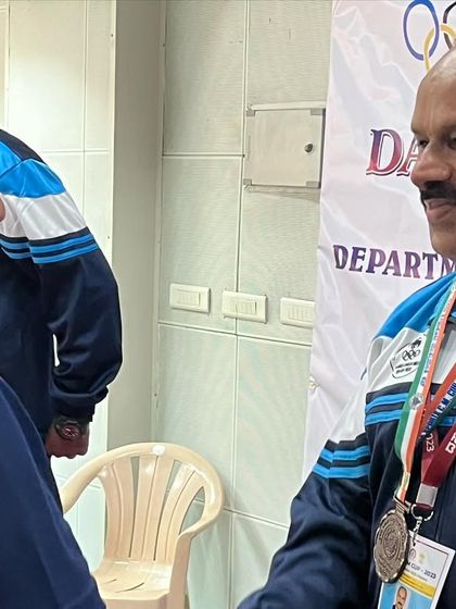 A moment of congratulations between fellow competitors after the 25m standard pistol event where I won a bronze medal.