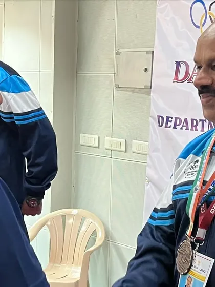 A moment of congratulations between fellow competitors after the 25m standard pistol event where I won a bronze medal.