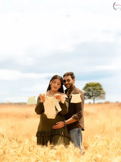 A cute and creative announcement shot, with a baby onesie hanging on a line between the expecting parents, Shireen and Hasan.