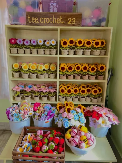 Welcome to my creative space. My shelves are always stocked with colorful yarn and finished products like these potted flowers and keychains, all ready to be assembled for the next big wholesale order.