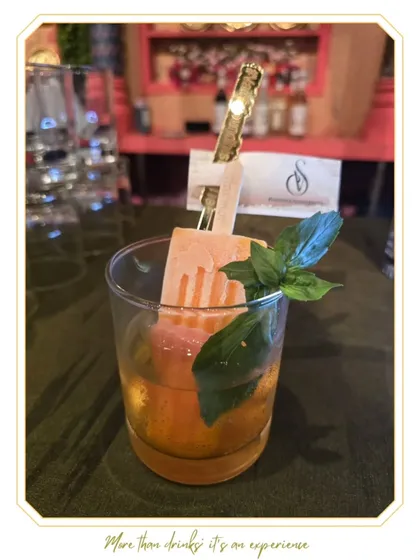 We love to innovate with playful and delicious concepts. This handcrafted popsicle cocktail, garnished with fresh basil, is an example of how we create unique, memorable, and interactive drink experiences for guests.