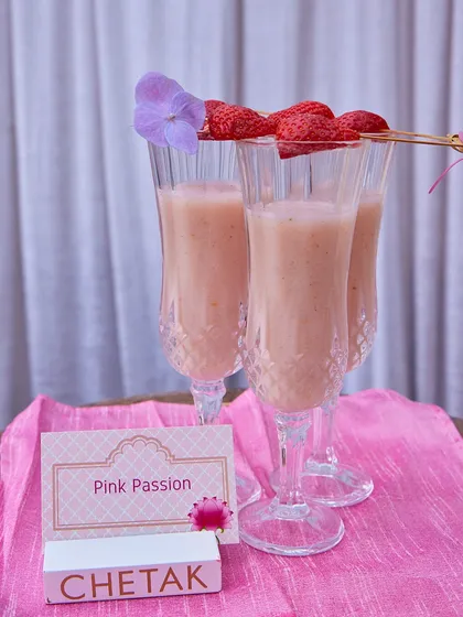 Our 'Pink Passion' mocktail, a creamy strawberry-based drink served in elegant flute glasses. The presentation is as delightful as the flavour.