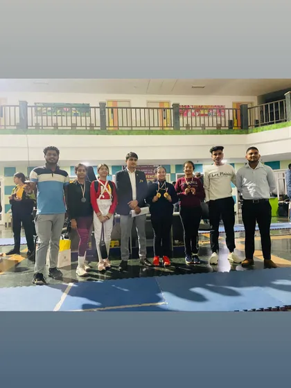 A group of our U-18 girls' medalists with their coaches, celebrating a successful tournament.