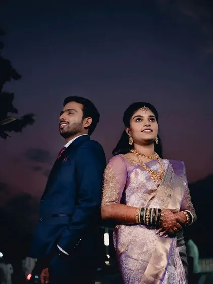 A creative twilight portrait of a couple. The beautiful colors of the sunset sky create a romantic and dramatic backdrop for this reception shot.