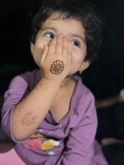 Look at that adorable pose. She is so happy with her little mandala mehendi. This shows how even a very simple and quick design can make a child feel so special and beautiful.