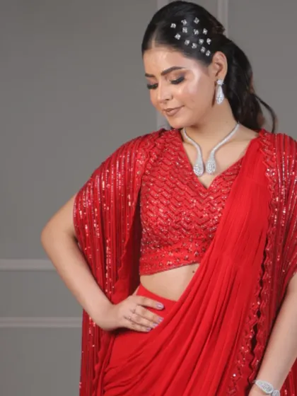 A full-length shot of the red saree look, showing how the entire ensemble comes together with the glamorous makeup and hair.