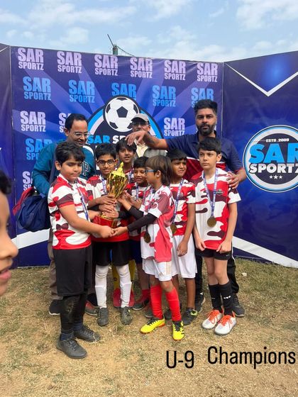 Our U-9 Champions proudly display their trophy, celebrating a fantastic victory in their age category.