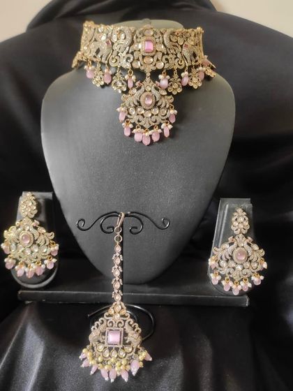A delicate Victorian choker set in a soft pink colour. This rental is a lovely, feminine option for an engagement party or a day wedding.