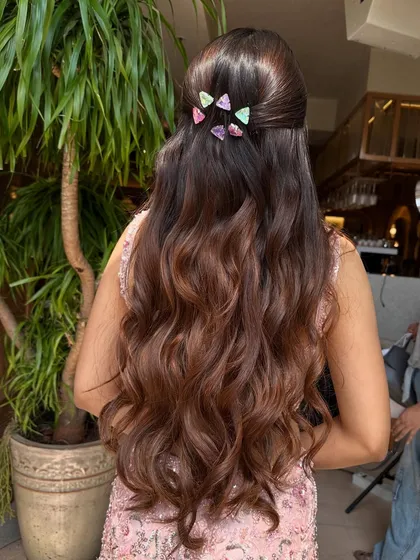 The full back view of the long, wavy hair with the fun, colorful clips, showing off a youthful and trendy look.