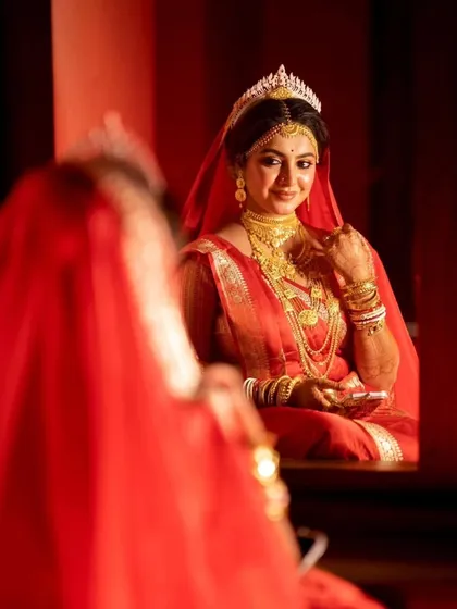 A real bride's stunning look in the mirror. This quiet, reflective moment before the ceremony is something I always try to capture, showing the bride in all her traditional glory.