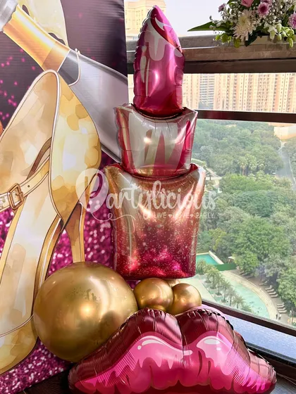 A close-up of the fun, glamorous details from our "Celebrating Me" setup. The lipstick and lip-shaped foil balloons add a playful and chic touch to the sophisticated color scheme.