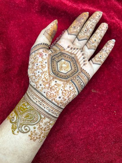 The completed minimalist design, with the hexagonal center surrounded by delicate heart-shaped vines and a simple paisley cuff.