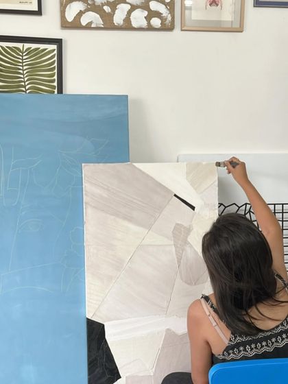 Another view of a studio session. Canvases in different stages of completion lean against each other, each telling a story of an idea in motion.