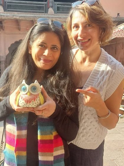A happy client at the Bhopal Potter's Market with her new owl figurine. I love the vibrant scarf that perfectly matches the colors in my work.