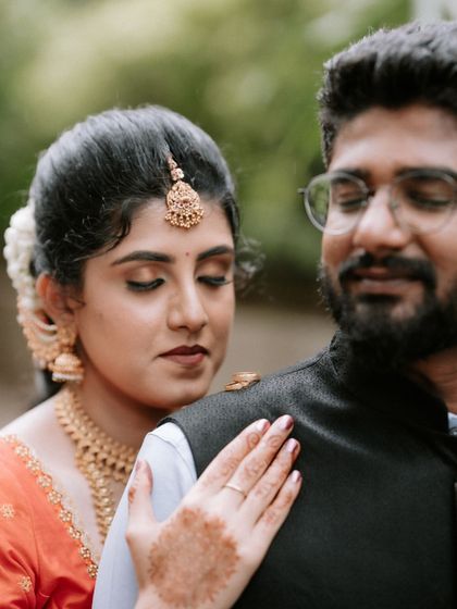 A creative and intimate portrait showing the engagement rings balanced on the groom's shoulder. It's a testament to our focus on unique, story-driven shots.