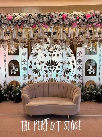 A full view of the "Perfect Stage," combining a dense floral canopy, hanging glass bells, and a beautiful illustrated backdrop for a truly unique design.