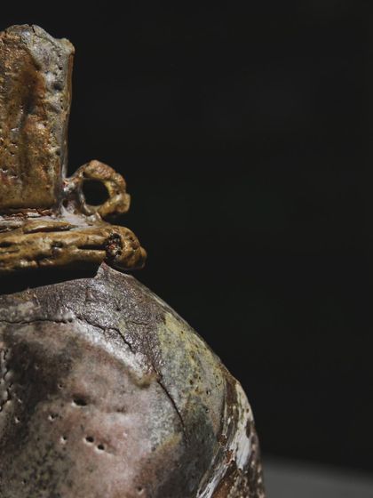A close-up of a wood-fired sculpture, showing the rich textures and cracks that form in the intense heat. This piece was made right after a demonstration by a mentor, reminding me of how sharing knowledge fuels growth.