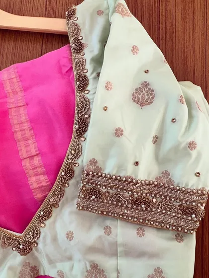 A close-up of the mint green blouse, showing the detailed zardosi and pearl embroidery along the V-neckline and sleeves.