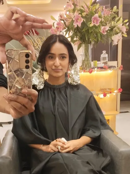 A mid-process mirror selfie showing the excitement of a hair transformation. The foils are in place, working their magic to create a beautiful new colour.