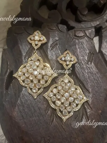 These large, geometric polki earrings are for those who love to make a statement. The intricate design is filled with sparkling polki stones, creating a piece that is both bold and beautiful.