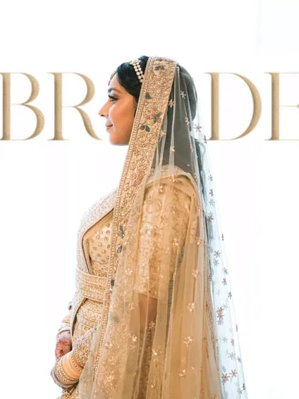 A high-key, minimalist portrait of the bride in profile against a white background.